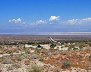 Panoramic photo of long deserted desert road